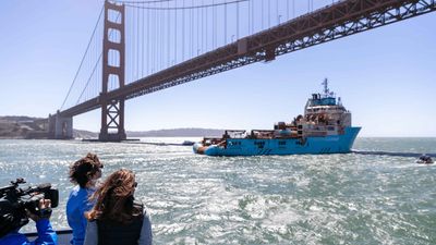 Boyan Slat kijkt naar een boot van The Ocean Cleanup